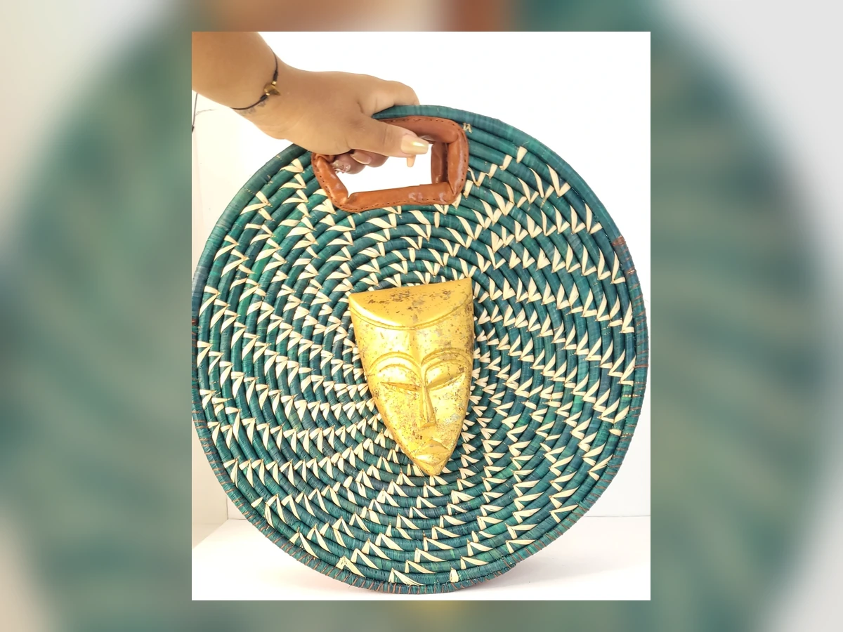 Teal handwoven circular Michmosh bag with gold mask detail