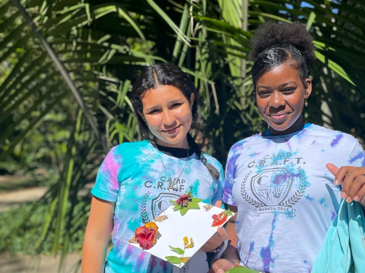 Children holding completed crafts at Unbox camp